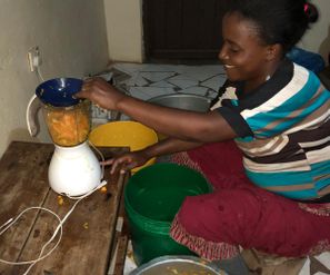 Dorin, mother of two preparing mango juice for her customers to support her family